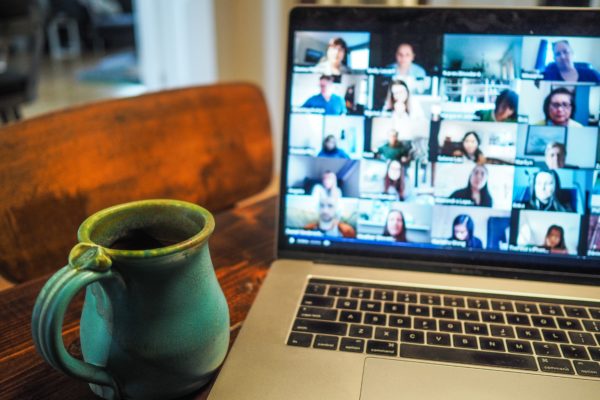 "How to Host a Virtual Funeral" - Computer with a conference call and coffee mug