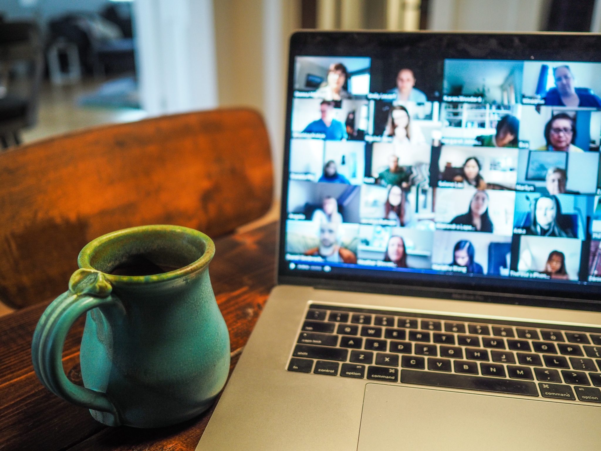 "How to Host a Virtual Funeral" - Computer with a conference call and coffee mug