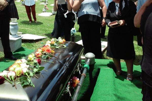 Casket with roses on top - Coping with Grief